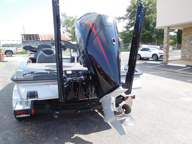 Slide: The Image of 2025 Caymas CX 21 PRO boat with powerful outboard motor in parking lot. - 12