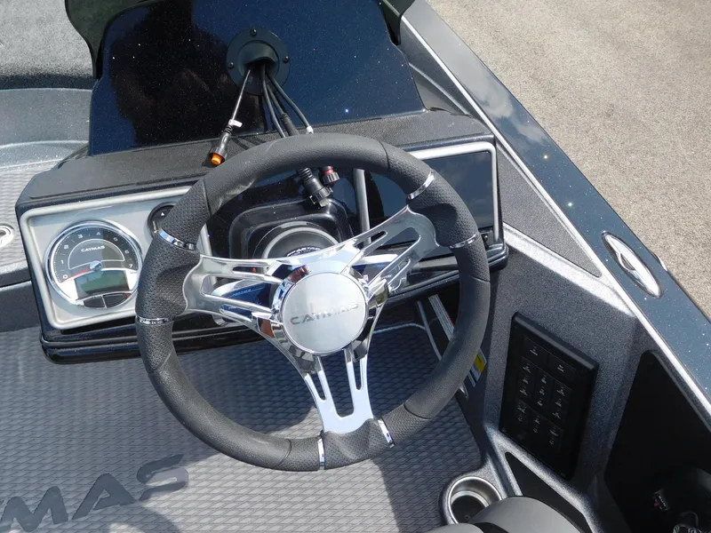 Slide: The Image of 2025 Caymas CX 21 PRO boat dashboard with steering wheel and gauges. - 2