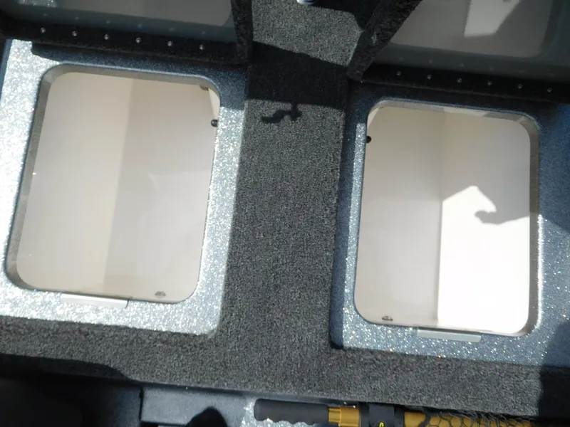 Slide: The Image of 2025 Caymas CX 21 PRO boat storage compartments with carpeted interior. - 8