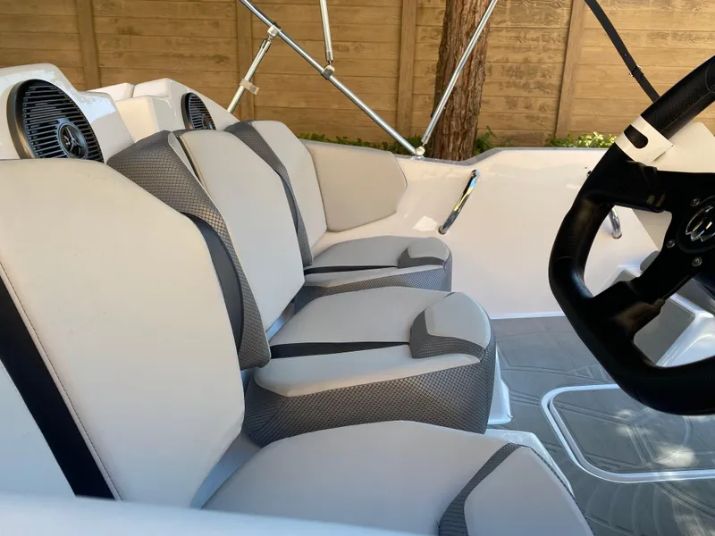 Slide: The Image of 2025 Scarab 165 SE boat interior with sleek seating and modern design. - 2