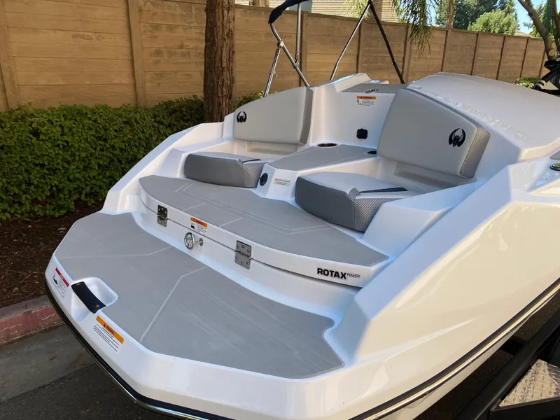Slide: The Image of 2025 Scarab 165 SE boat with Rotax engine, featuring sleek white and gray seating. - 6