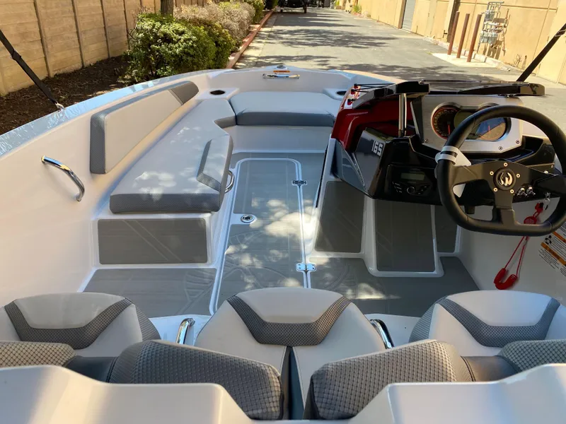 Slide: The Image of 2025 Scarab 165 SE boat interior with modern seating and steering console. - 7