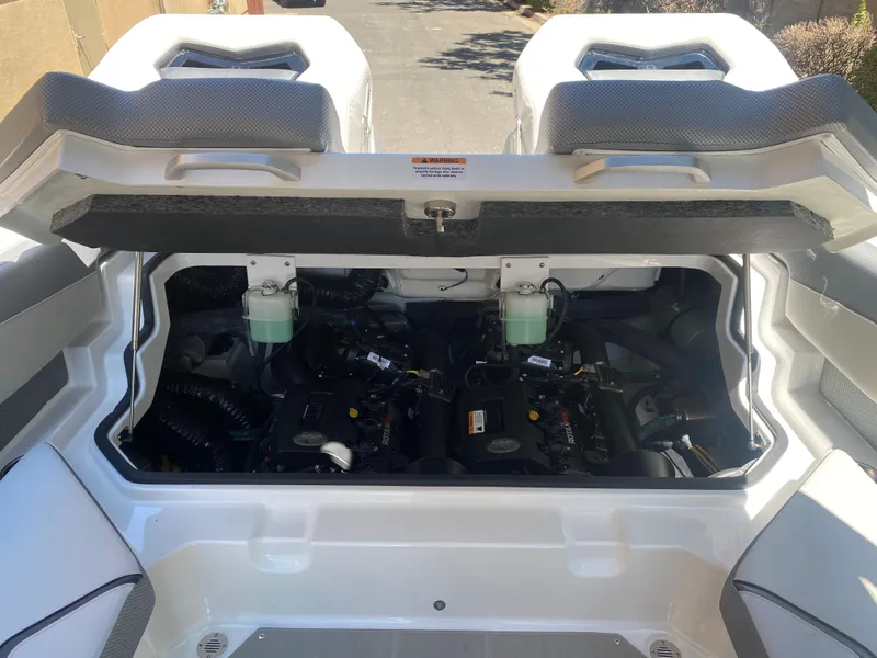 Slide: The Image of 2025 Scarab 235 SE engine compartment with open hatch, showcasing dual engines. - 19