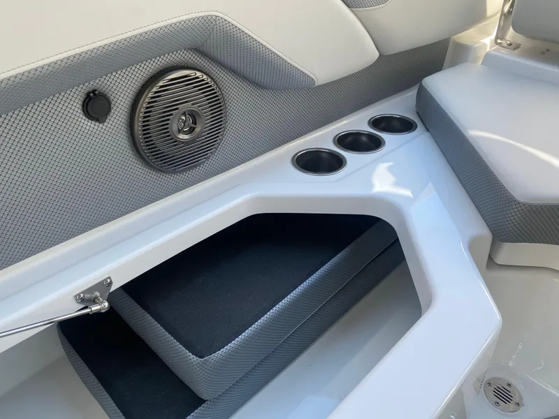 Slide: The Image of 2025 Scarab 235 SE boat interior with speaker, cup holders, and seating. - 22