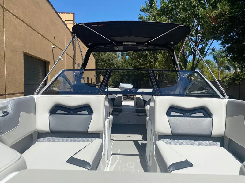 Slide: The Image of 2025 Scarab 235 SE boat interior with modern seating and canopy. - 24