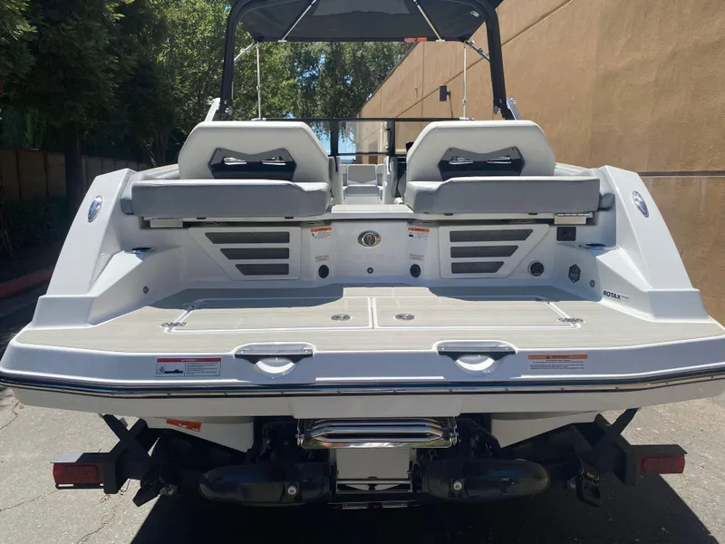 Slide: The Image of 2025 Scarab 235 SE boat rear view, showcasing seating and deck design. - 7