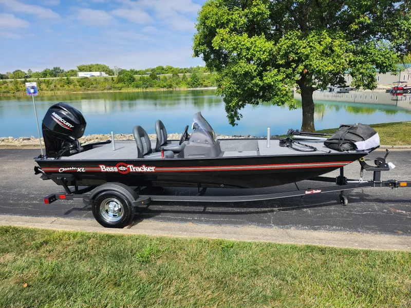 Slide: The Image of 2022 Tracker Bass Tracker Classic XL boat parked by a scenic lake. - 10