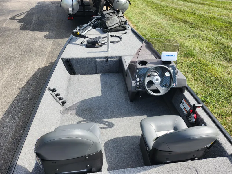 Slide: The Image of 2022 Tracker Bass Tracker Classic XL boat interior with steering wheel and seating. - 11