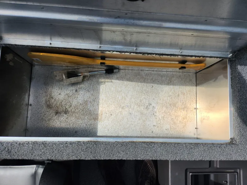 Slide: The Image of 2022 Tracker Bass Tracker Classic XL storage compartment, empty with tools inside. - 21