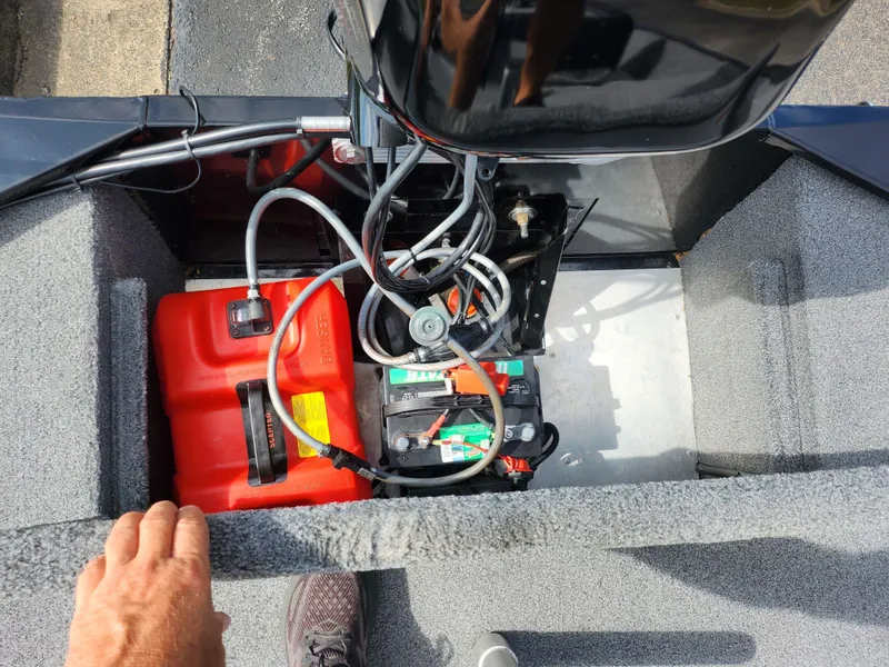 Slide: The Image of 2022 Tracker Bass Tracker Classic XL boat engine compartment with battery and fuel tank. - 22