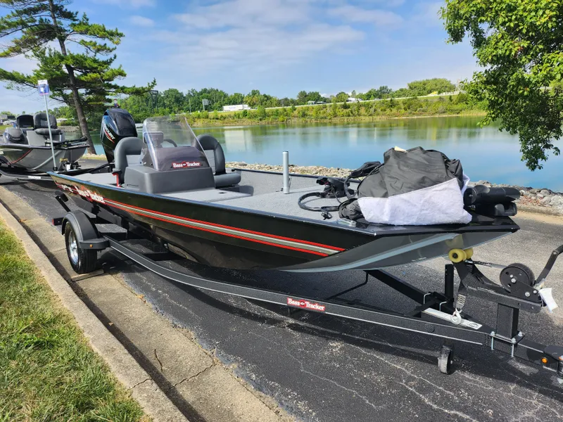 Slide: The Image of 2022 Tracker Bass Tracker Classic XL boat by a scenic lake. - 9