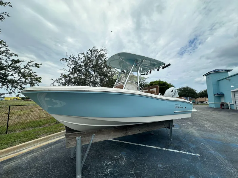 The Image of 2025 Pioneer 202 Islander boat on display, light blue hull, outdoor setting. - 1