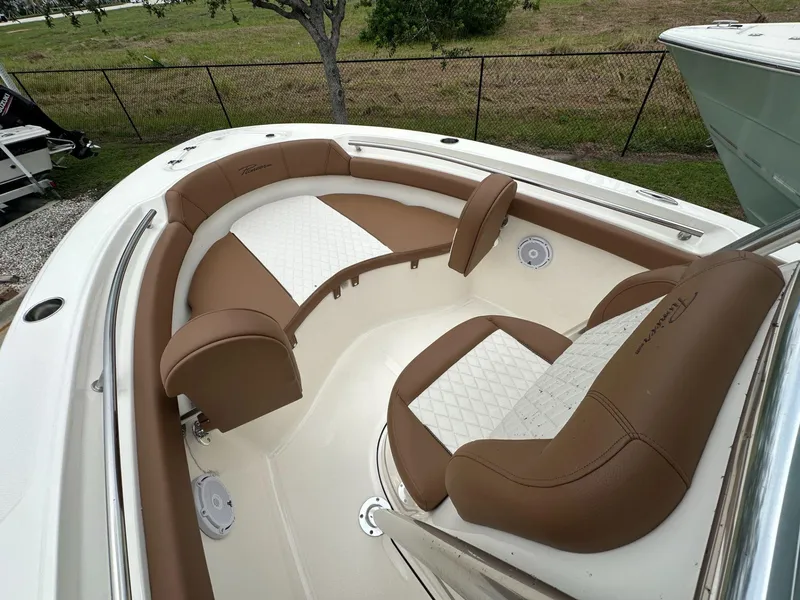 Slide: The Image of 2025 Pioneer 202 Islander boat interior with brown and white cushioned seating. - 5