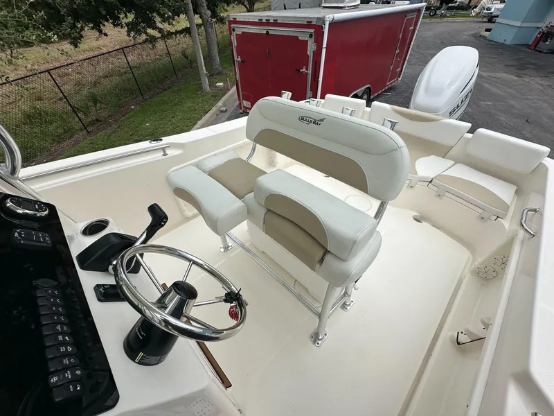 Slide: The Image of 2025 Bulls Bay 230 CC boat interior with steering wheel and seating. - 10