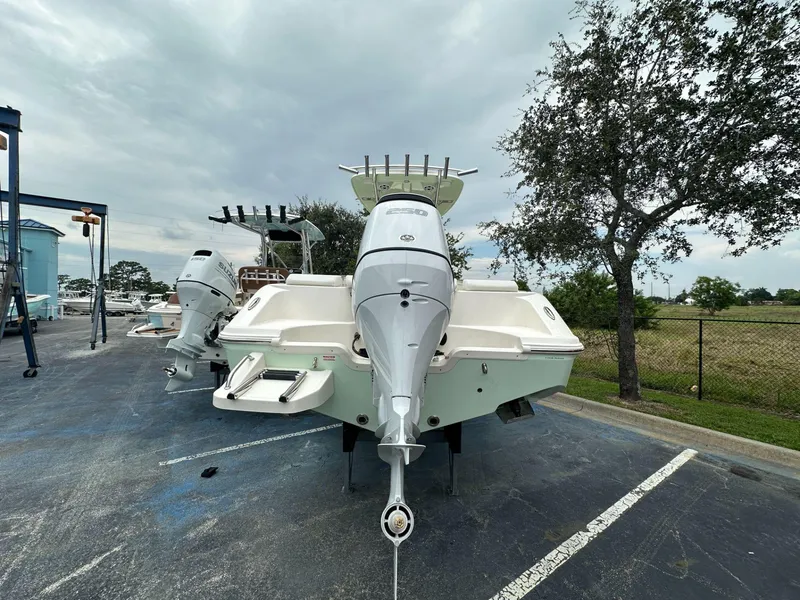 Slide: The Image of 2025 Bulls Bay 230 CC boat with outboard motor in parking lot. - 4