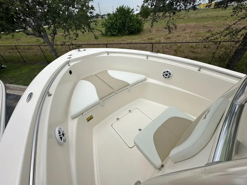 Slide: The Image of 2025 Bulls Bay 230 CC boat interior with cushioned seating and speakers. - 7
