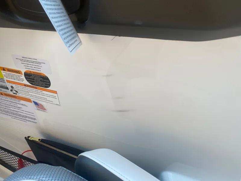 Slide: The Image of Interior view of a 2025 Scarab 255 ID boat with safety instructions. - 13