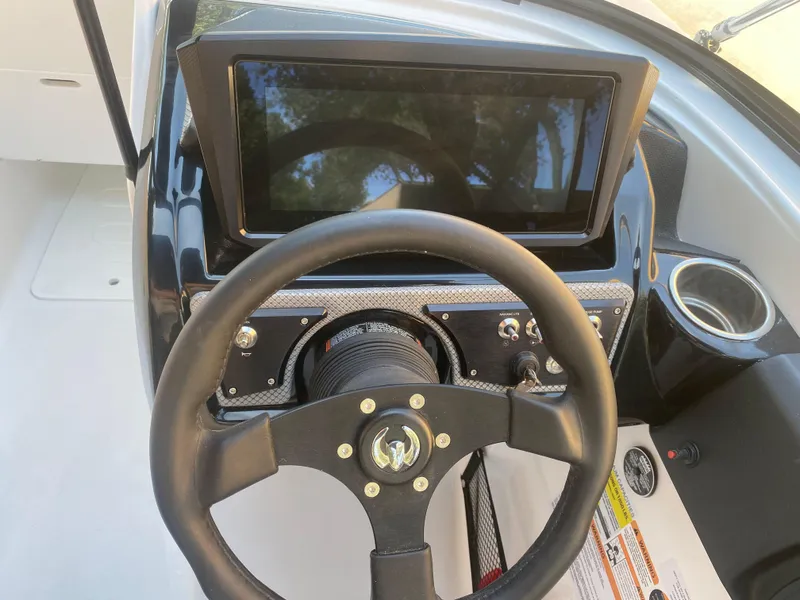 Slide: The Image of Steering wheel and dashboard of 2025 Scarab 255 ID boat. - 14