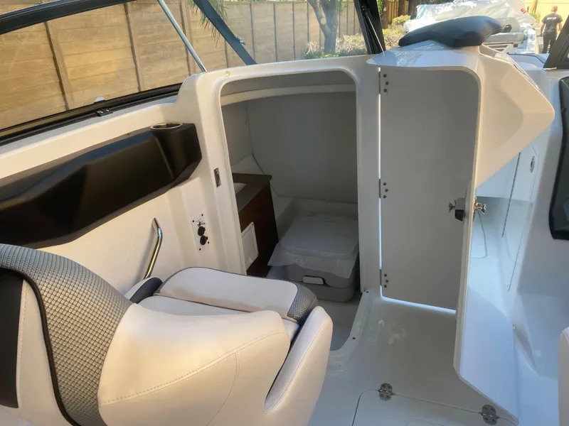 Slide: The Image of 2025 Scarab 255 ID boat interior with seating and cabin access. - 20