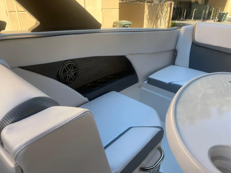 Slide: The Image of Interior of 2025 Scarab 255 ID boat with white seating and sleek design. - 23