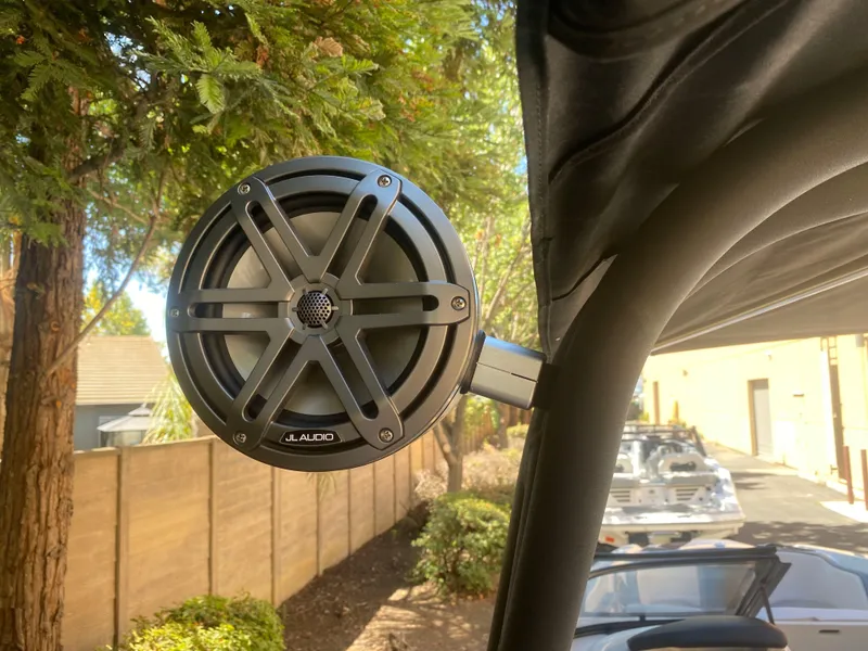 Slide: The Image of JL Audio speaker mounted on a 2025 Scarab 255 ID boat, outdoor setting. - 28