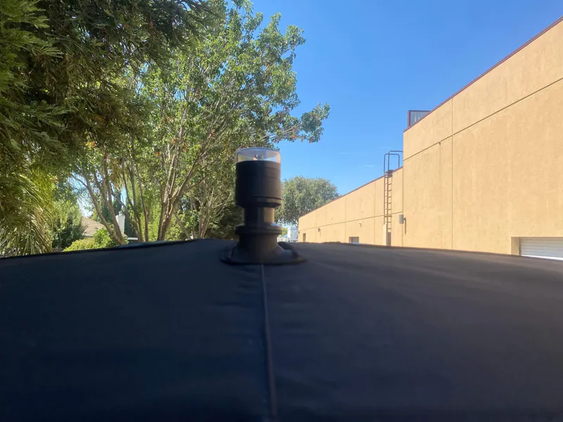 Slide: The Image of Rooftop view of 2025 Scarab 255 ID with clear blue sky and trees. - 29