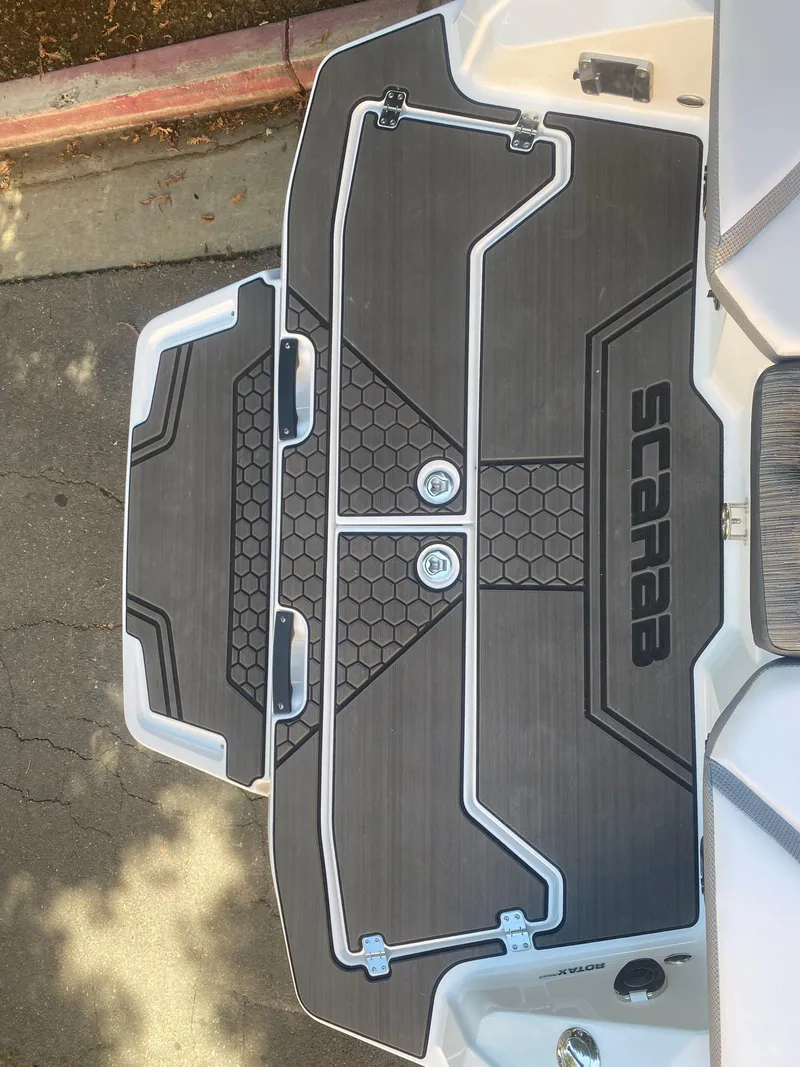 Slide: The Image of 2025 Scarab 255 ID boat deck with sleek black and white design. - 32