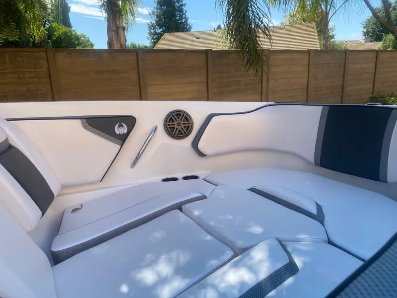 Slide: The Image of 2025 Scarab 255 ID boat interior with white seating and speaker detail. - 8