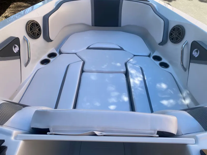 Slide: The Image of 2025 Scarab 255 ID boat interior with cushioned seating and cup holders. - 9