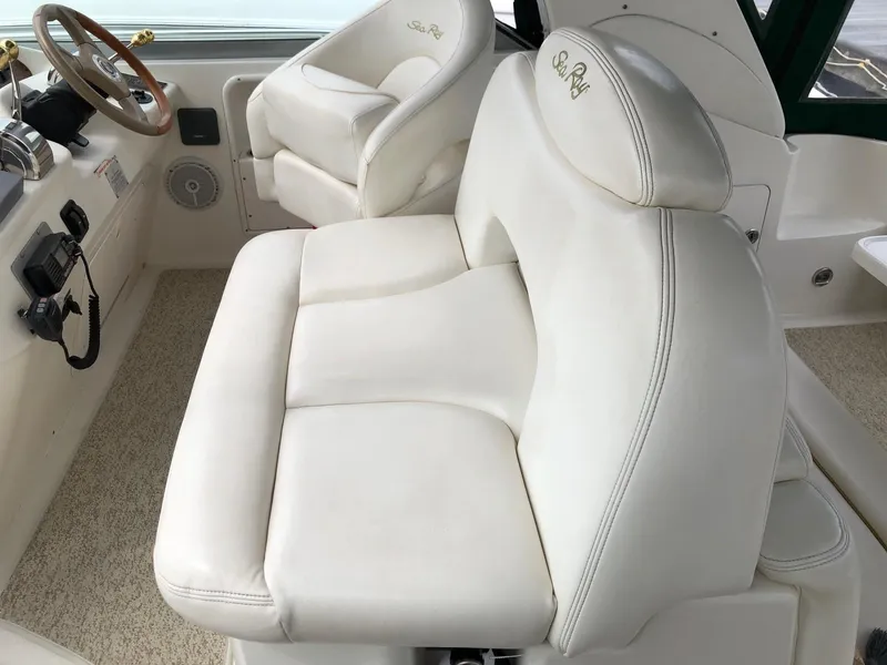 Slide: The Image of 2001 Sea Ray 340 Sundancer cockpit with white leather seating and steering wheel. - 11