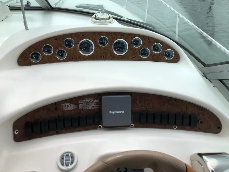 Slide: The Image of Dashboard of 2001 Sea Ray 340 Sundancer boat with gauges and Raymarine equipment. - 13