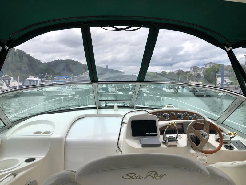 Slide: The Image of 2001 Sea Ray 340 Sundancer cockpit view with marina backdrop. - 15