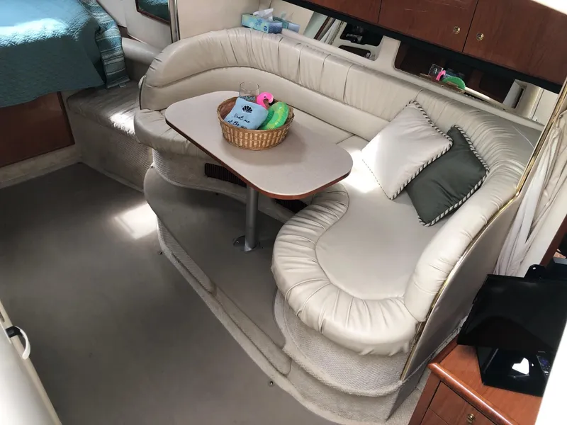 Slide: The Image of Interior of 2001 Sea Ray 340 Sundancer with curved seating and table. - 17