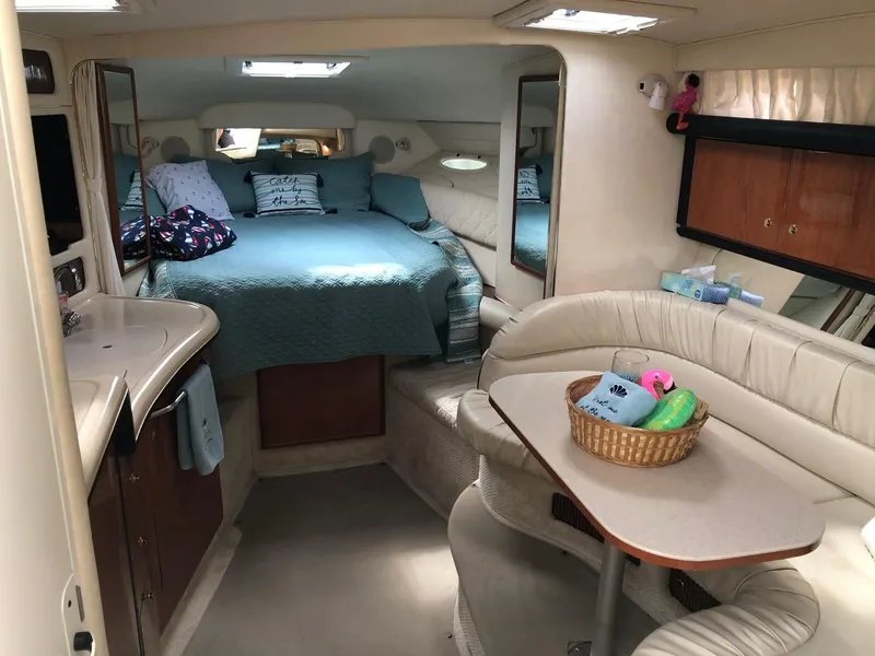 Slide: The Image of Interior of 2001 Sea Ray 340 Sundancer yacht with cozy bed and dining area. - 18