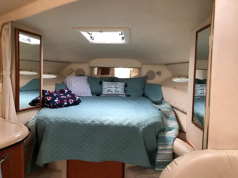 Slide: The Image of Interior cabin of 2001 Sea Ray 340 Sundancer with cozy bed and nautical decor. - 19