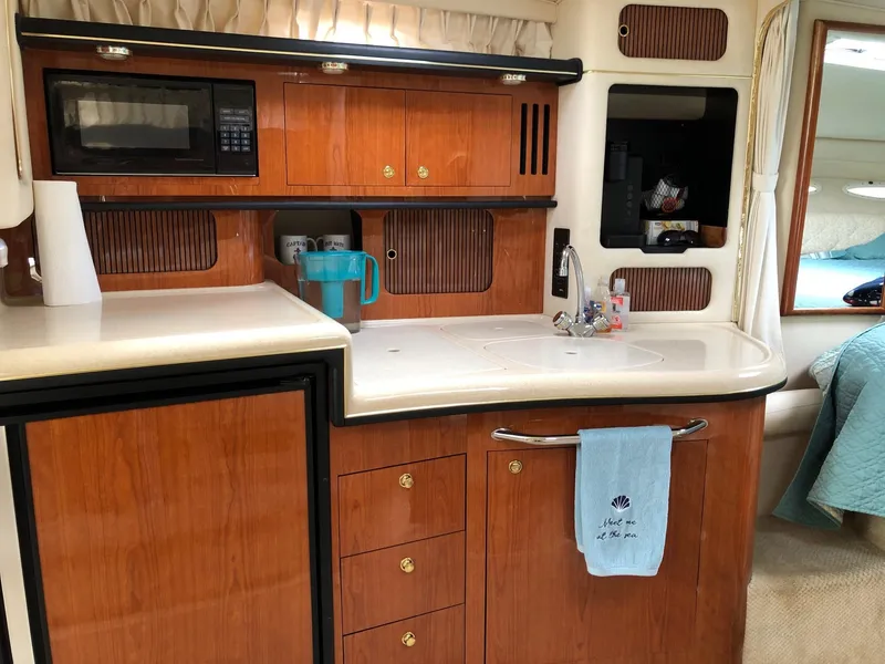 Slide: The Image of Interior of 2001 Sea Ray 340 Sundancer yacht kitchen with wood cabinetry and modern appliances. - 20
