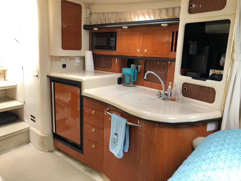 Slide: The Image of Interior of 2001 Sea Ray 340 Sundancer yacht kitchen with wood cabinetry and modern appliances. - 21