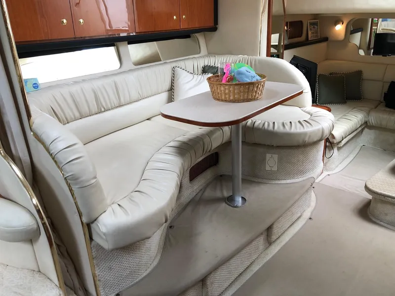 Slide: The Image of Luxurious interior of 2001 Sea Ray 340 Sundancer yacht with plush seating and table. - 22