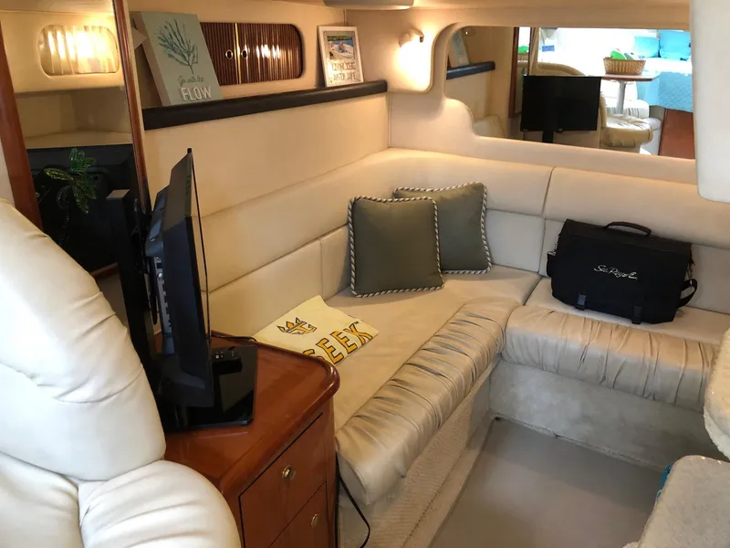 Slide: The Image of Interior of 2001 Sea Ray 340 Sundancer yacht with cozy seating and TV. - 24