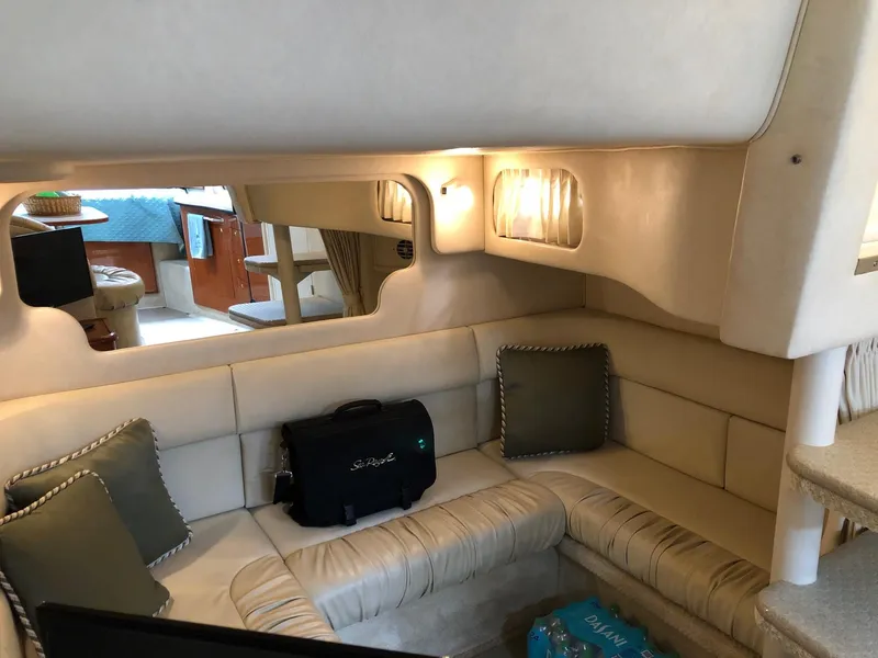 Slide: The Image of Interior of 2001 Sea Ray 340 Sundancer yacht with cozy seating area. - 25