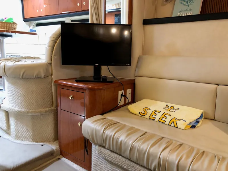 Slide: The Image of Interior of 2001 Sea Ray 340 Sundancer with TV and seating area. - 26