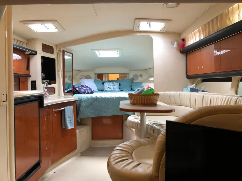 Slide: The Image of Interior of 2001 Sea Ray 340 Sundancer yacht with cozy seating and kitchenette. - 27