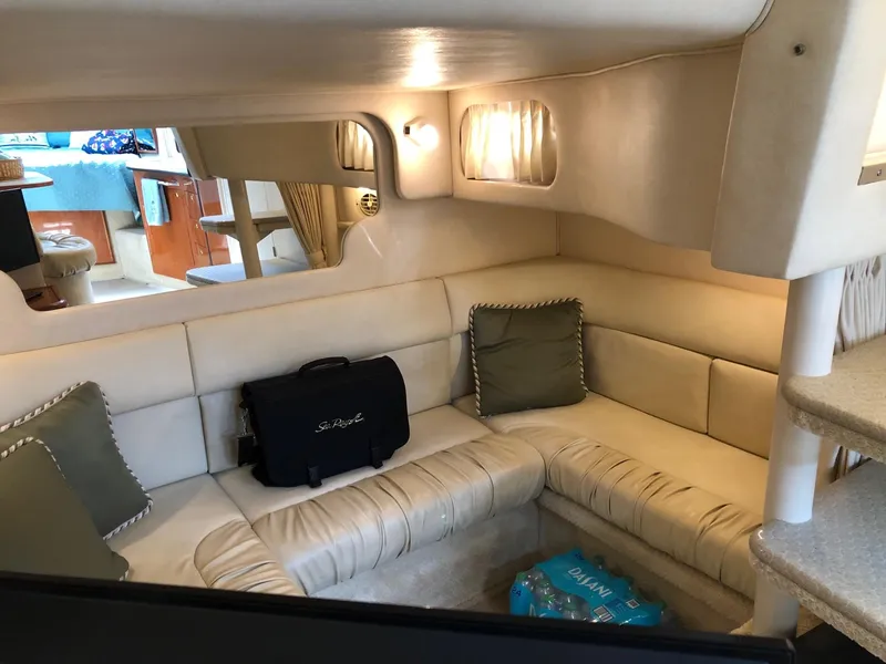 Slide: The Image of Interior of 2001 Sea Ray 340 Sundancer with beige seating and cozy lighting. - 28