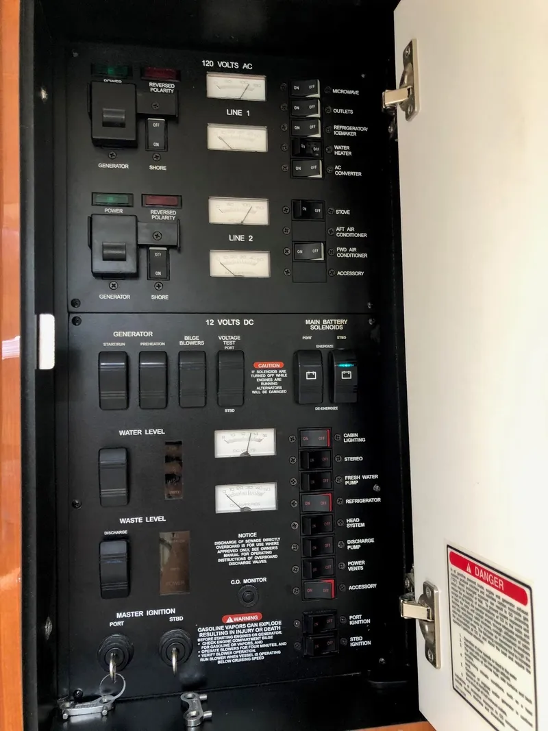 Slide: The Image of Electrical panel of 2001 Sea Ray 340 Sundancer boat, showing switches and controls. - 31