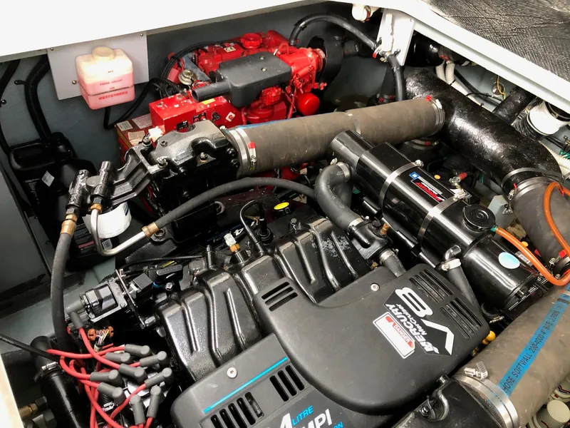 Slide: The Image of Engine compartment of a 2001 Sea Ray 340 Sundancer boat, showcasing detailed mechanical components. - 33