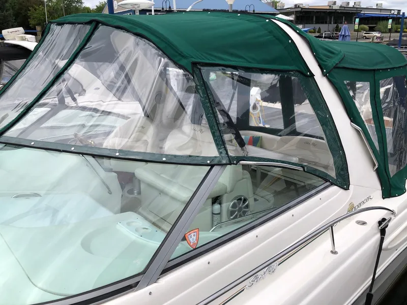 Slide: The Image of 2001 Sea Ray 340 Sundancer with green canopy, docked at marina. - 6