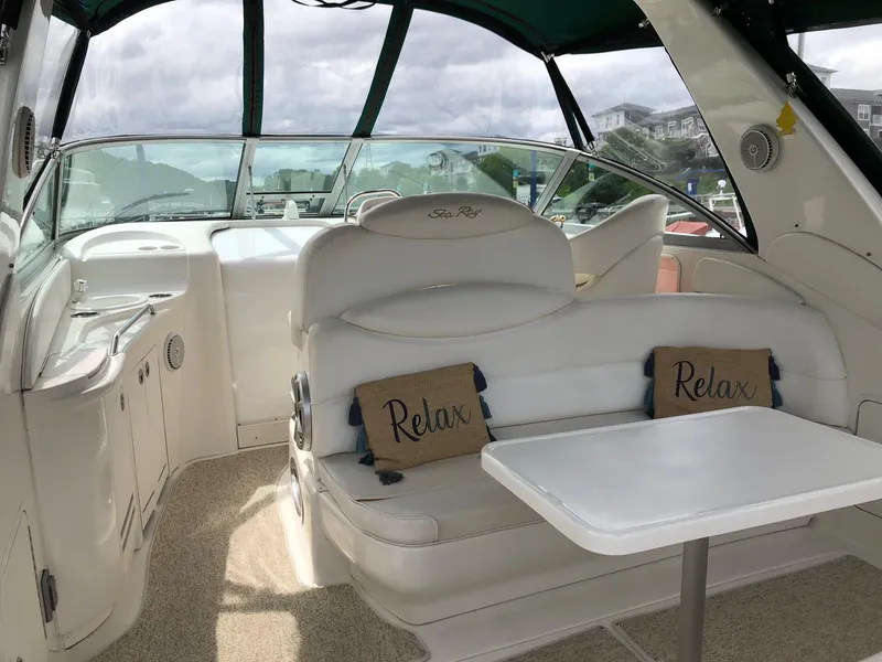 Slide: The Image of 2001 Sea Ray 340 Sundancer interior with white seating and "Relax" pillows. - 8