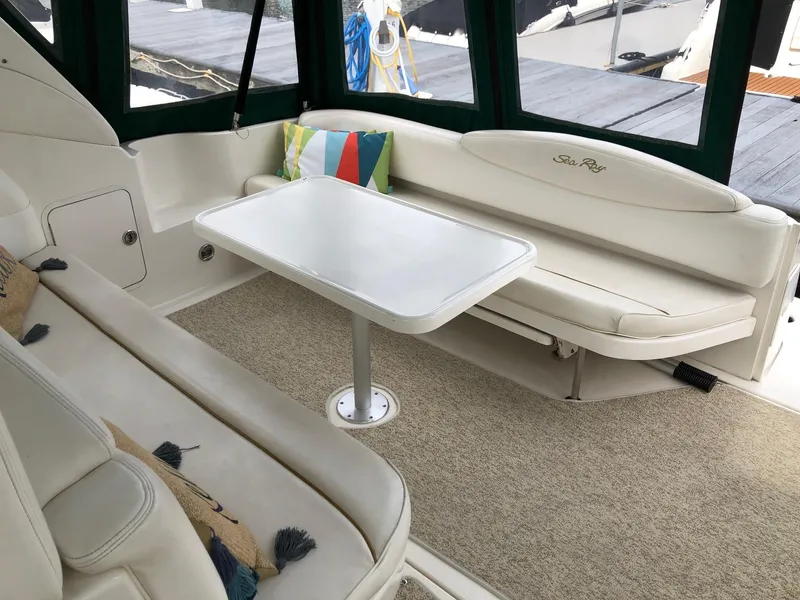 Slide: The Image of Interior of 2001 Sea Ray 340 Sundancer with white seating and table. - 9