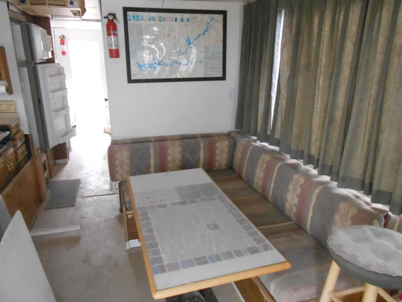 Slide: The Image of 1972 Boatel Hurcules interior with dining area, map, and curtains. - 11