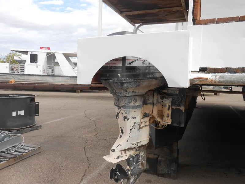 Slide: The Image of 1972 Boatel Hurcules boat engine, partially covered, in a parking area. - 4